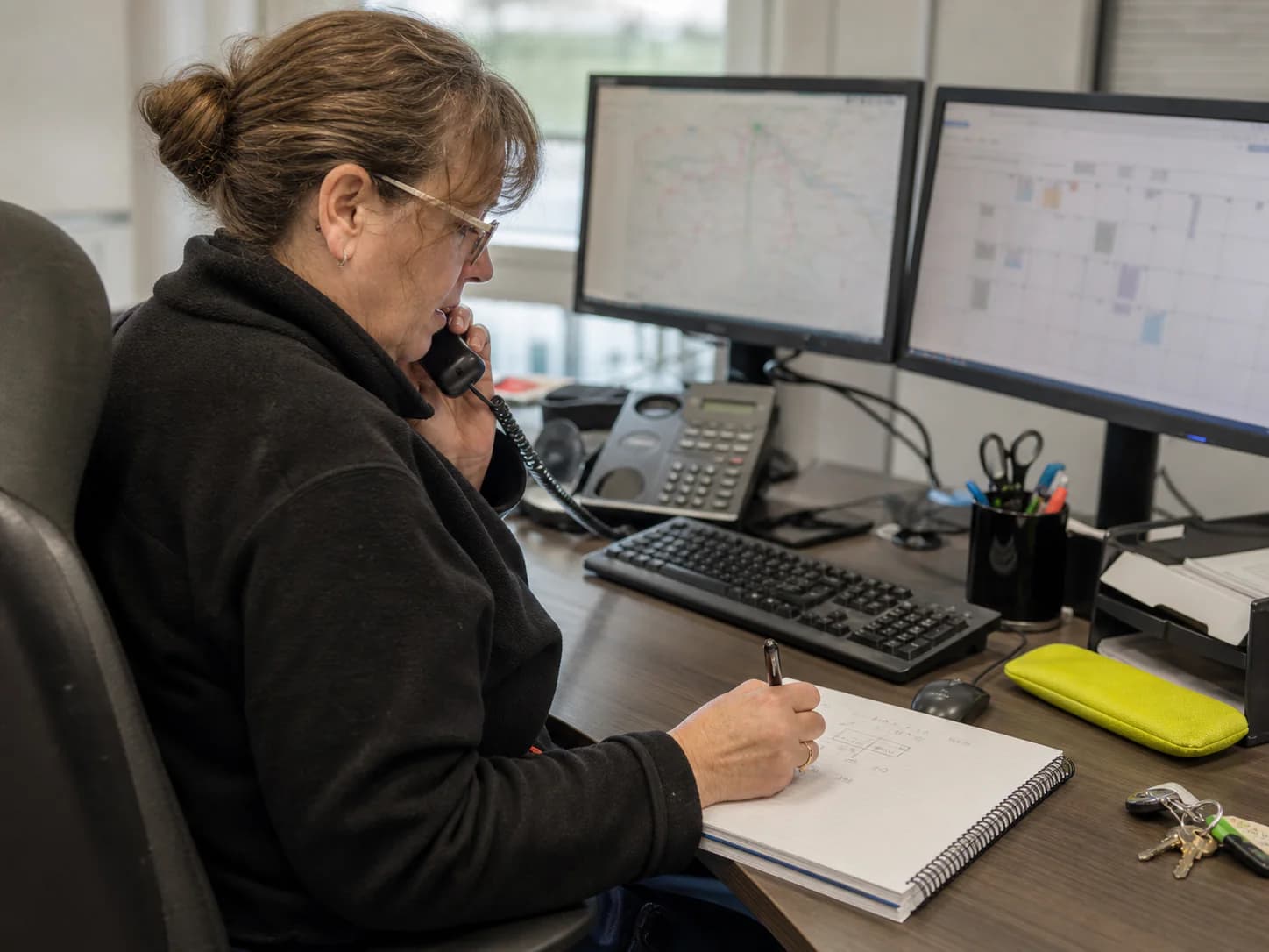 A Ufirst booking coordinator taking journey details over the phone