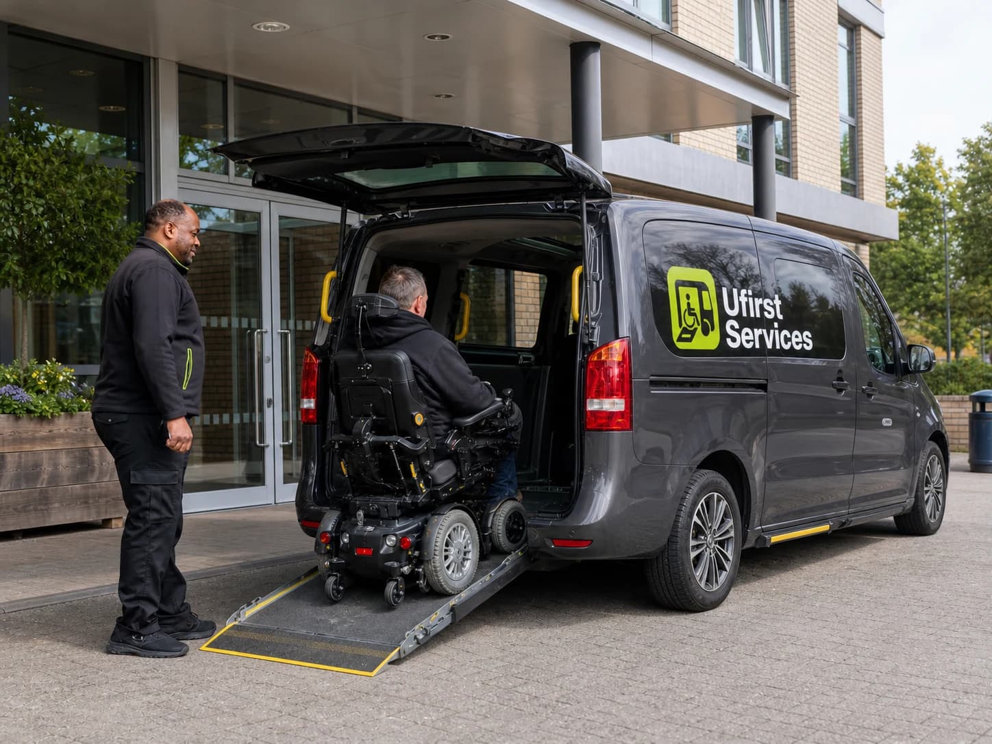 A family member and a Ufirst driver assisting a passenger into an accessible vehicle outside a home